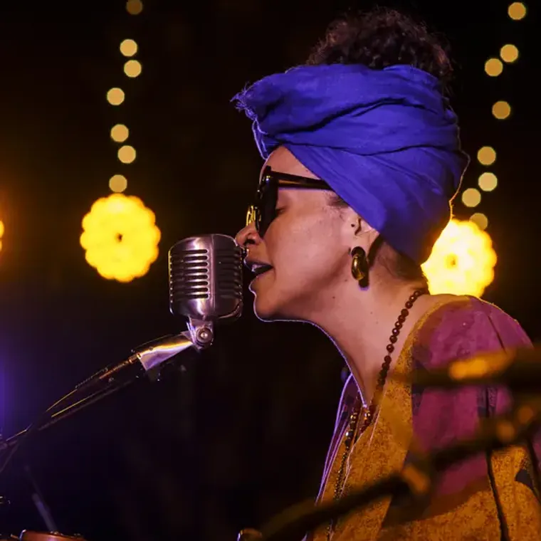 Rita Donte cantando con turbante azul